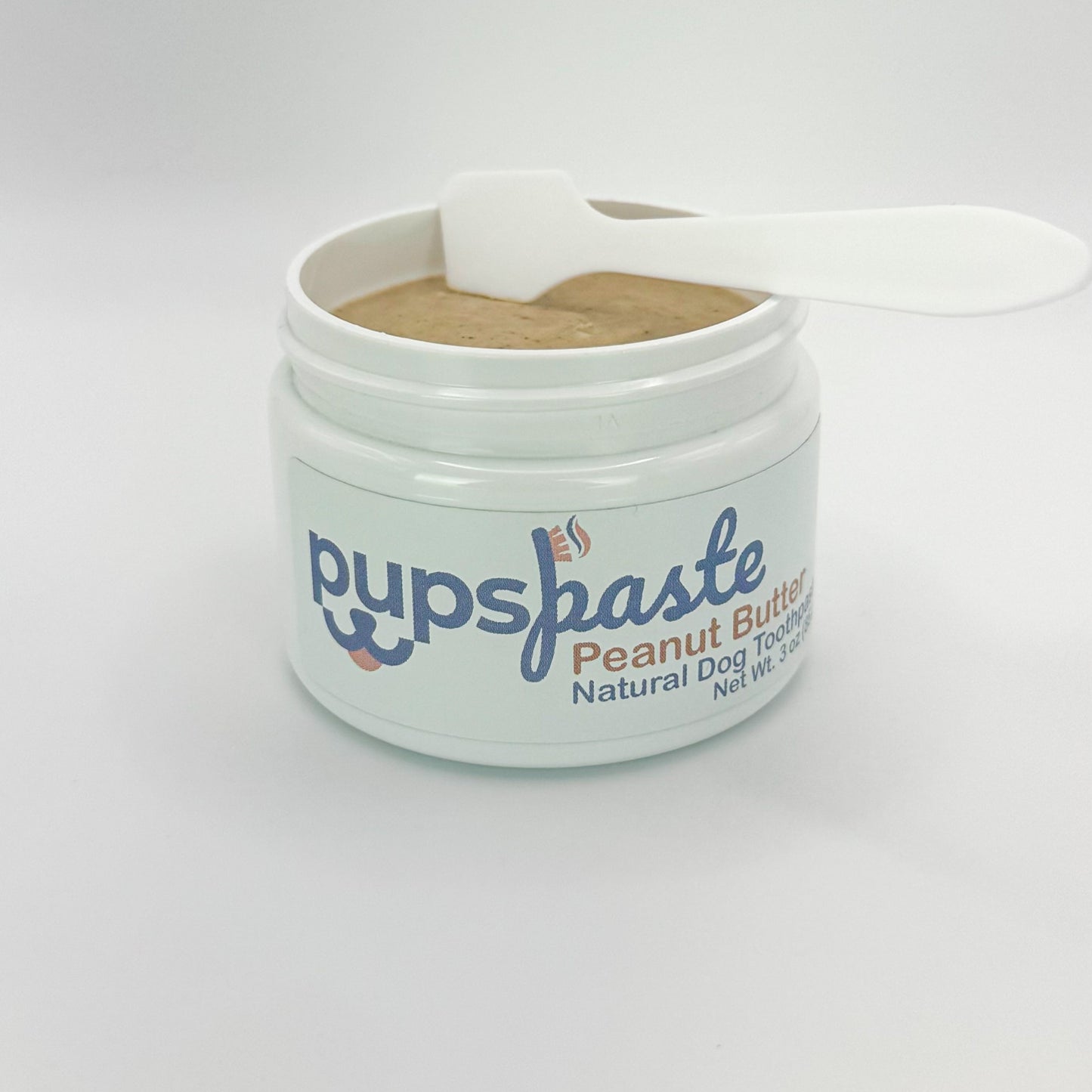 Peanut butter dog toothpaste jar with toothbrush applicator