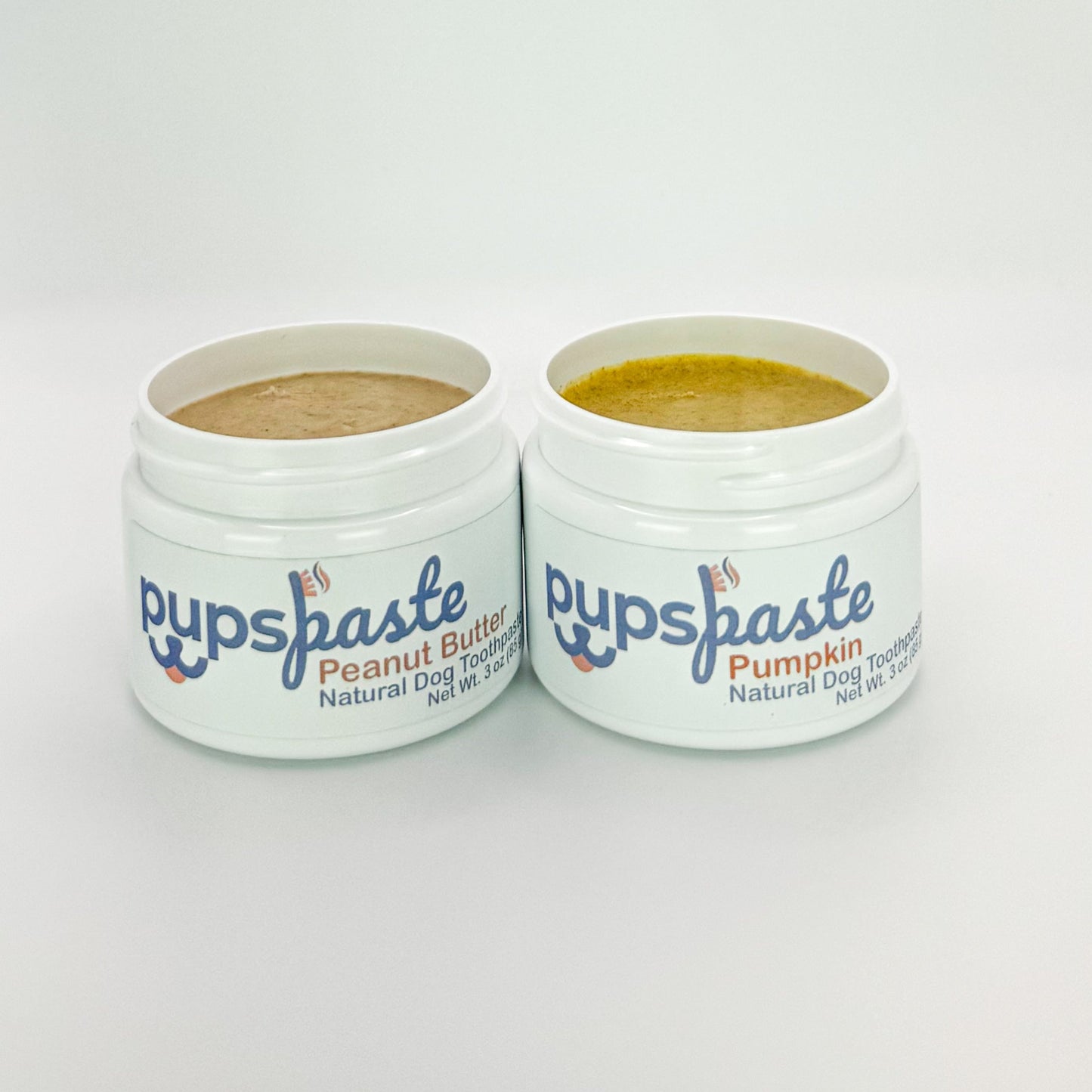 Peanut butter and pumpkin dog toothpaste duo pack with lids off