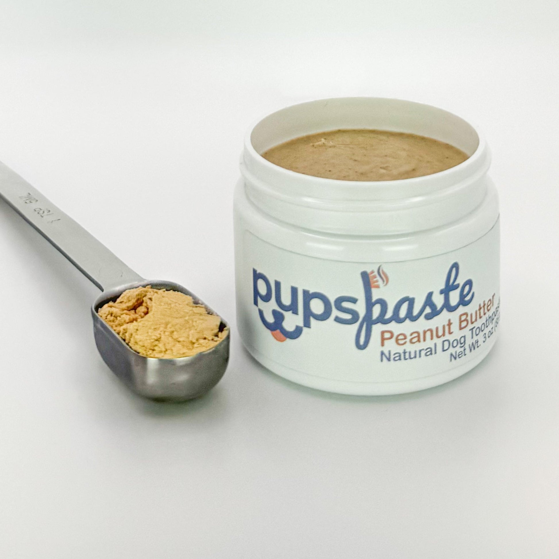 Peanut butter dog toothpaste shown with peanut butter powder