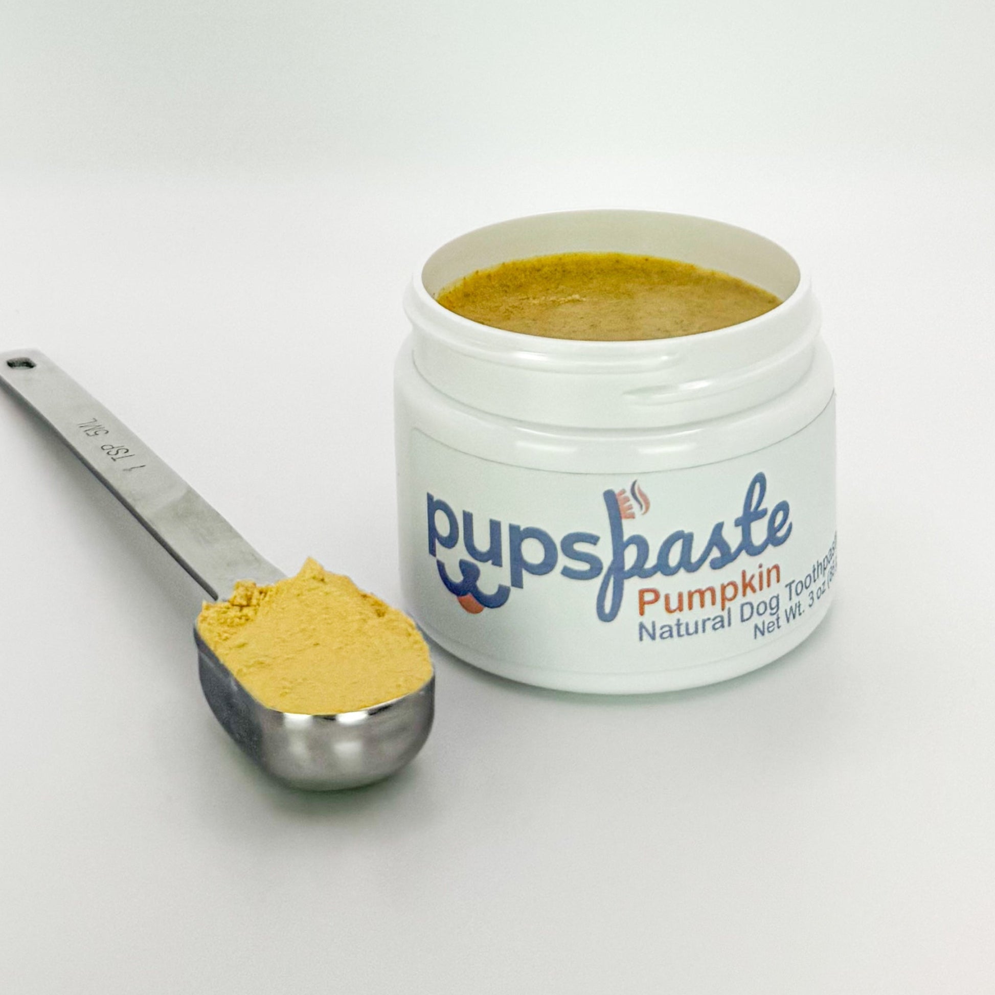 Pumpkin dog toothpaste shown with pumpkin powder